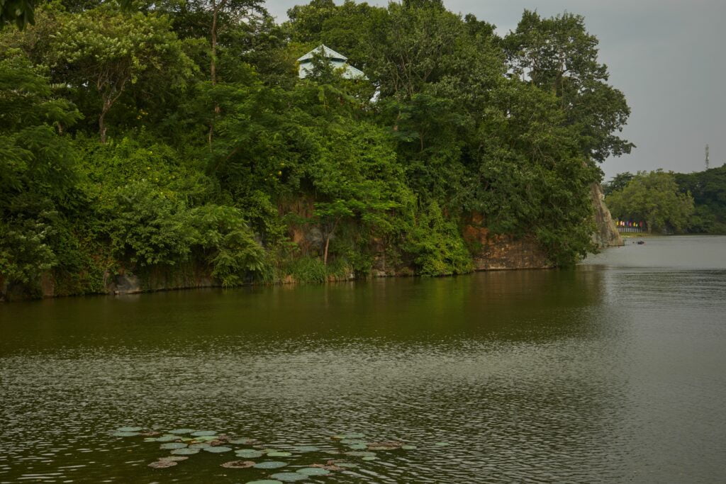 Beautiful lake in front of a rock covered in trees, Buu Long, Ho Chi Minh City, Vietnam