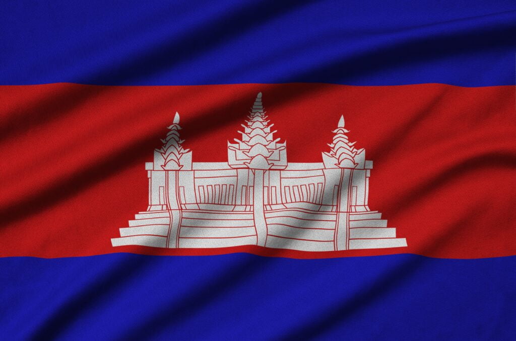 Cambodia flag is depicted on a sports cloth fabric with many folds. Sport team waving banner