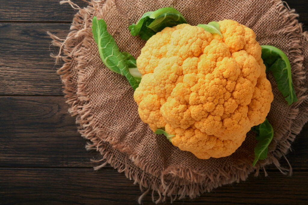 Colorful cauliflower. Various sort of cauliflower on old wooden background. Purple, yellow, white an