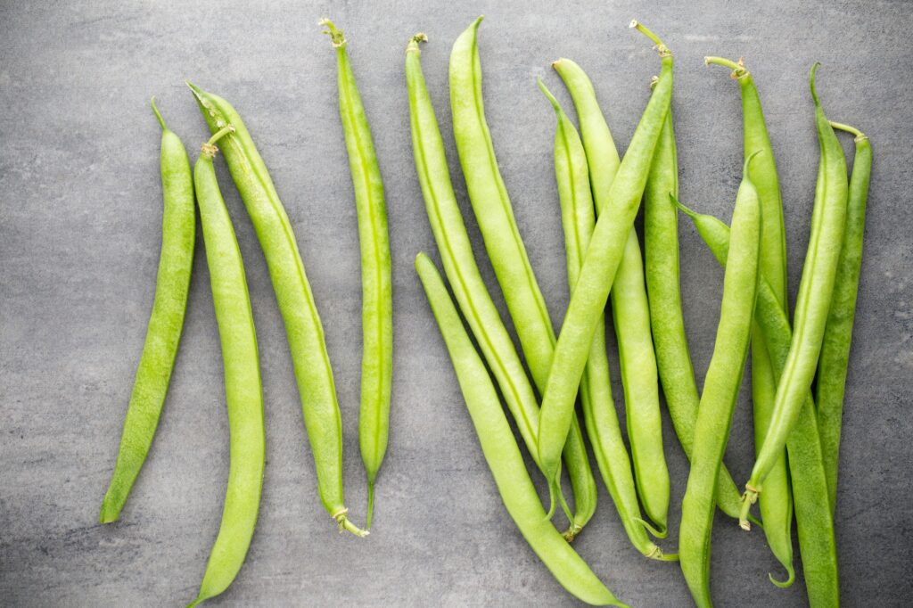 Green beans on a gray background.